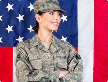 female latina veteran standing in front of flag